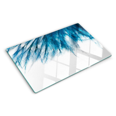 Glass chopping board Blue feathers on a white background