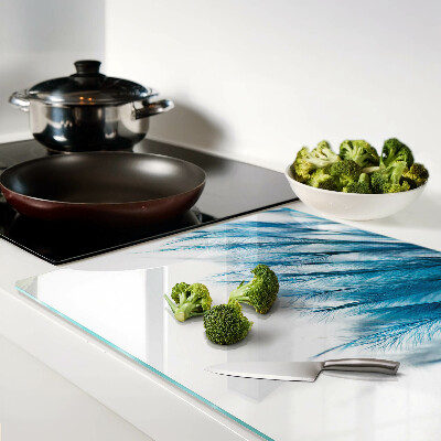 Glass chopping board Blue feathers on a white background