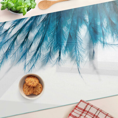 Glass chopping board Blue feathers on a white background