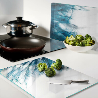 Glass chopping board Blue feathers on a white background