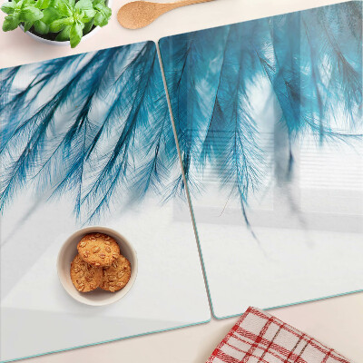 Glass chopping board Blue feathers on a white background