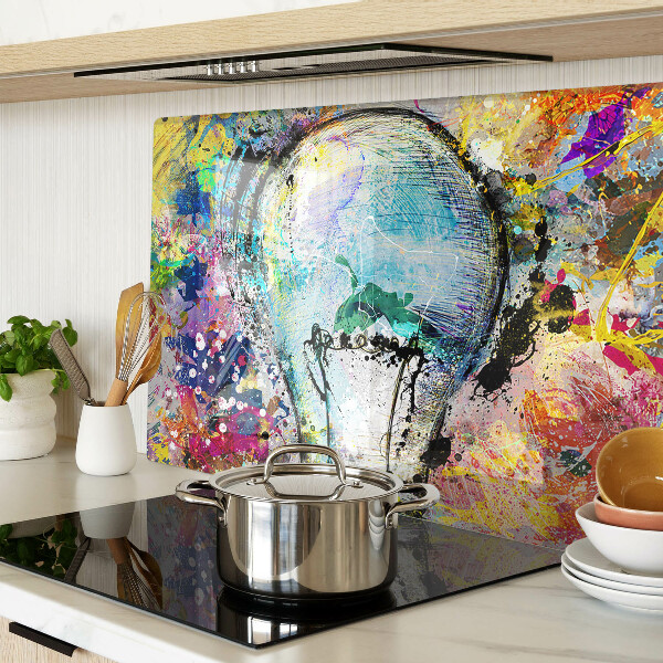 Glass kitchen board Light bulb on a colored background