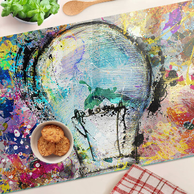 Glass kitchen board Light bulb on a colored background
