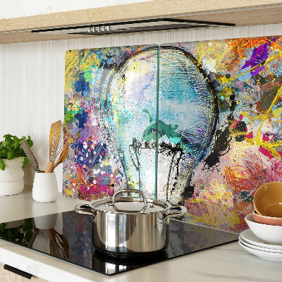 Glass kitchen board Light bulb on a colored background