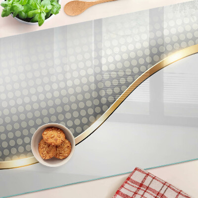 Glass chopping board A golden wave on a background of dots