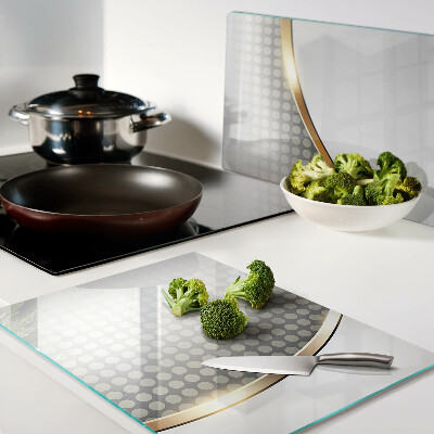 Glass chopping board A golden wave on a background of dots