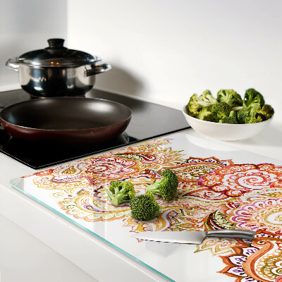 Chopping board glass Paisley motif in shades of red and gold