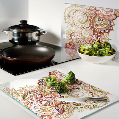 Chopping board glass Paisley motif in shades of red and gold