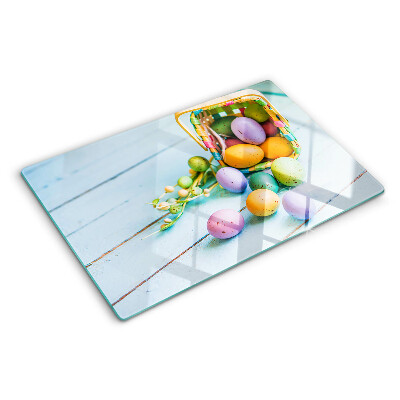 Glass chopping board Easter colored eggs in a basket