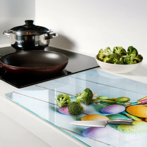 Glass chopping board Easter colored eggs in a basket