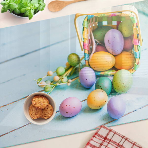 Glass chopping board Easter colored eggs in a basket
