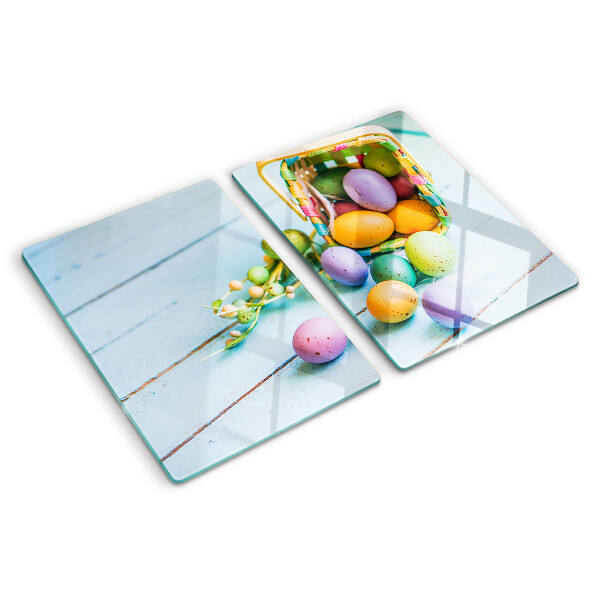 Glass chopping board Easter colored eggs in a basket