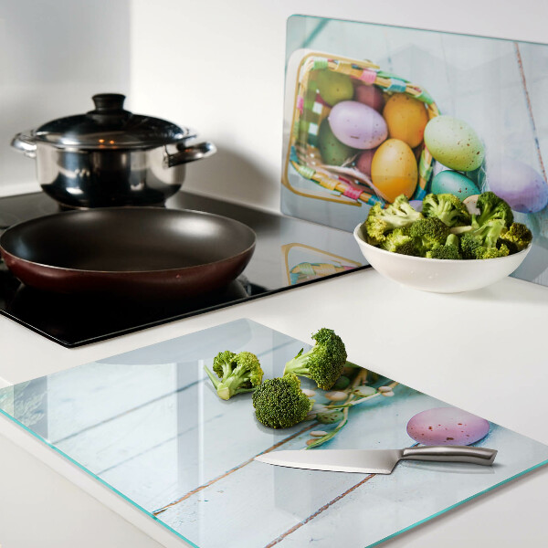 Glass chopping board Easter colored eggs in a basket