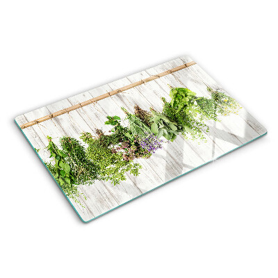 Chopping board glass Herbs on a wooden background