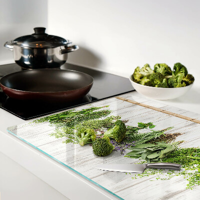 Chopping board glass Herbs on a wooden background