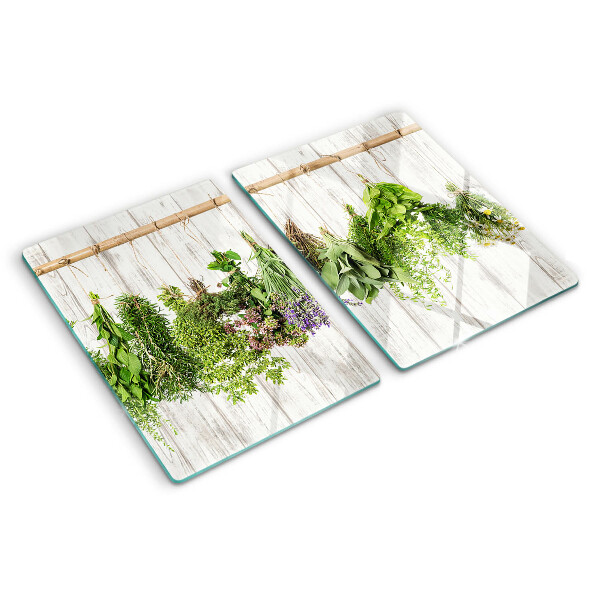Chopping board glass Herbs on a wooden background
