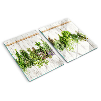 Chopping board glass Herbs on a wooden background