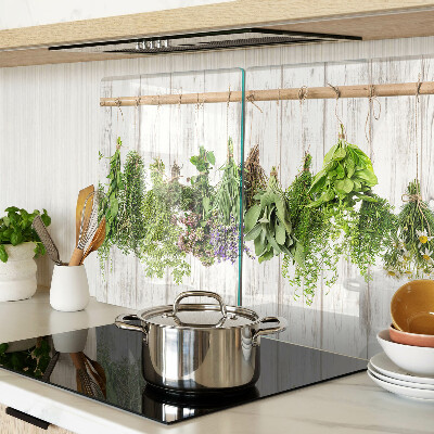 Chopping board glass Herbs on a wooden background