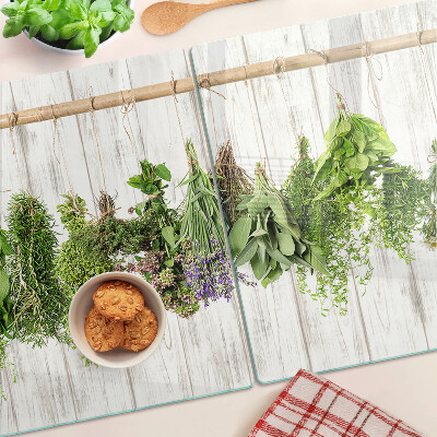 Chopping board glass Herbs on a wooden background