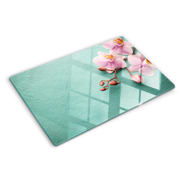 Glass cutting board Orchids on a blue background