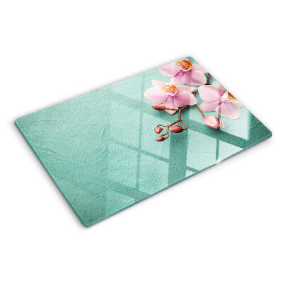 Glass cutting board Orchids on a blue background