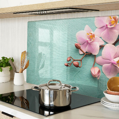 Glass cutting board Orchids on a blue background