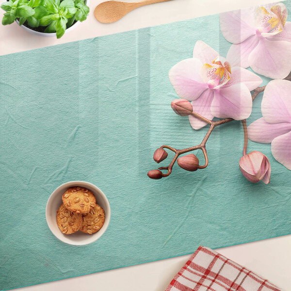 Glass cutting board Orchids on a blue background