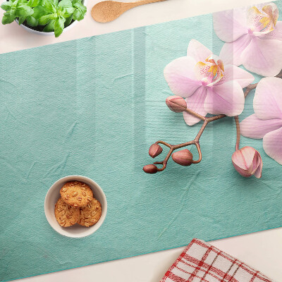 Glass cutting board Orchids on a blue background