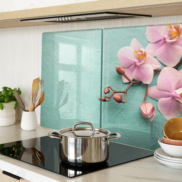 Glass cutting board Orchids on a blue background