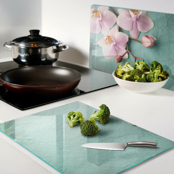 Glass cutting board Orchids on a blue background