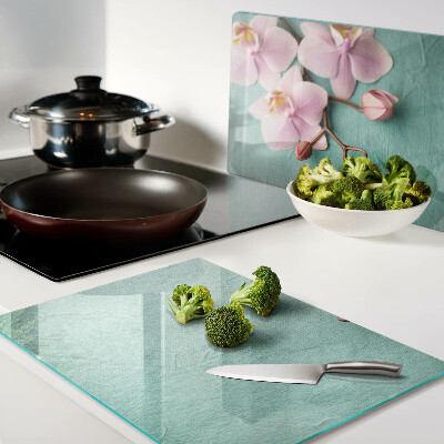 Glass cutting board Orchids on a blue background