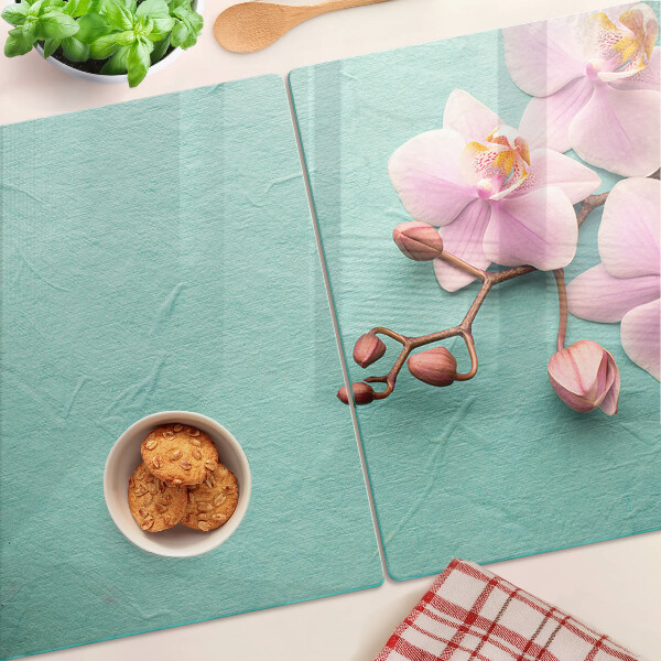 Glass cutting board Orchids on a blue background