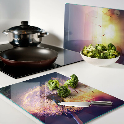 Chopping board Dandelions against the sunset background