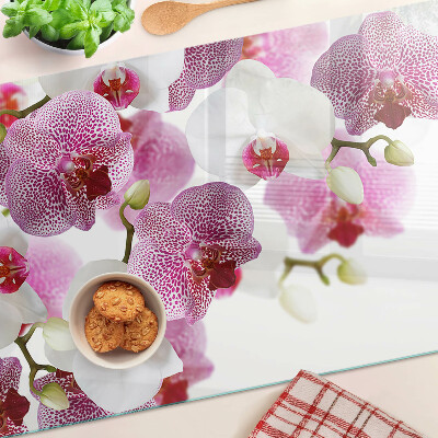 Chopping board glass Orchids in the background of the window