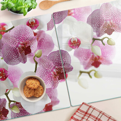 Chopping board glass Orchids in the background of the window