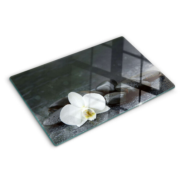 Glass kitchen board Orchid flower on stones