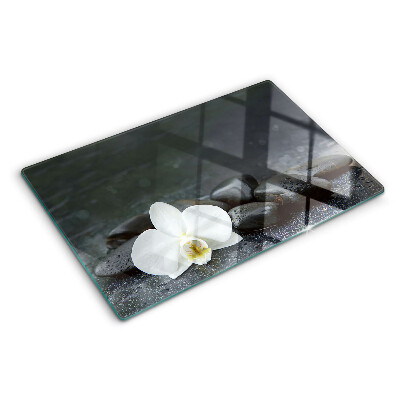 Glass kitchen board Orchid flower on stones