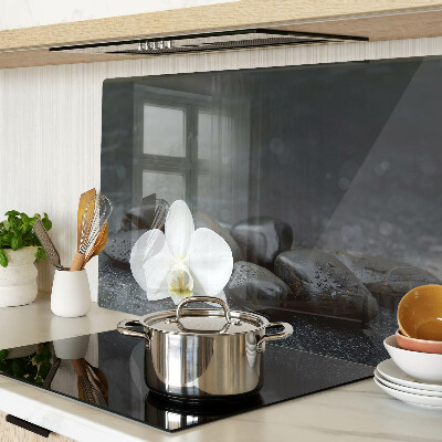 Glass kitchen board Orchid flower on stones