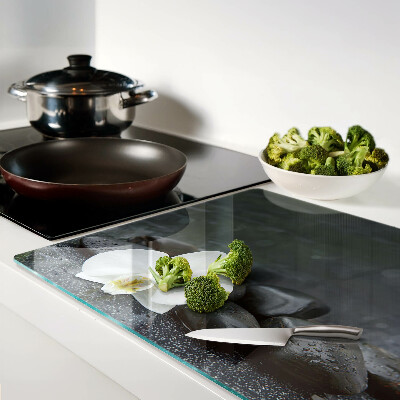 Glass kitchen board Orchid flower on stones