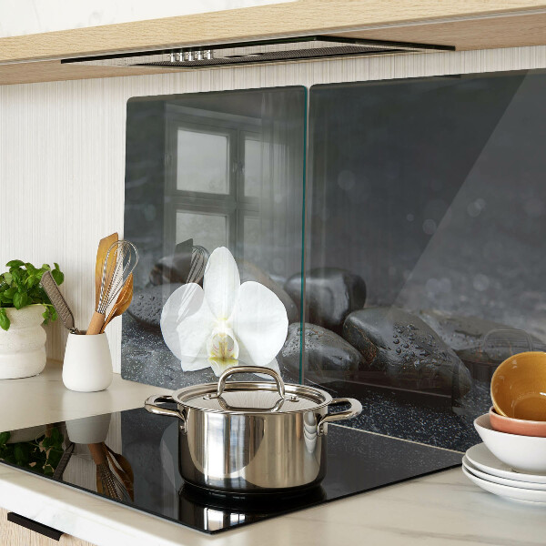 Glass kitchen board Orchid flower on stones