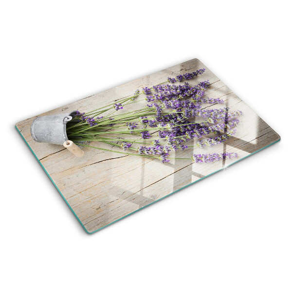 Chopping board glass Lavender in a pot on a wooden background