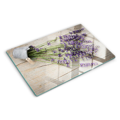 Chopping board glass Lavender in a pot on a wooden background