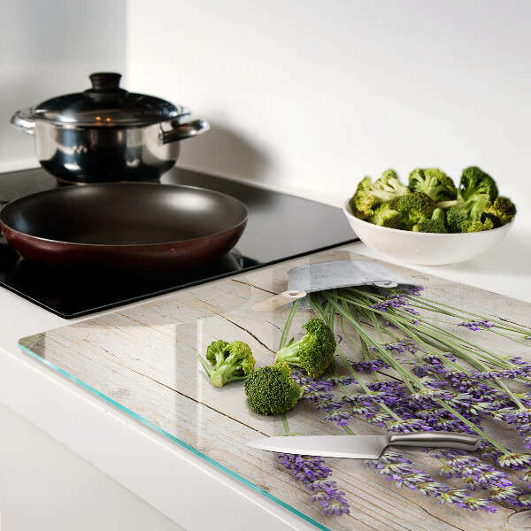 Chopping board glass Lavender in a pot on a wooden background