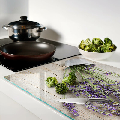 Chopping board glass Lavender in a pot on a wooden background