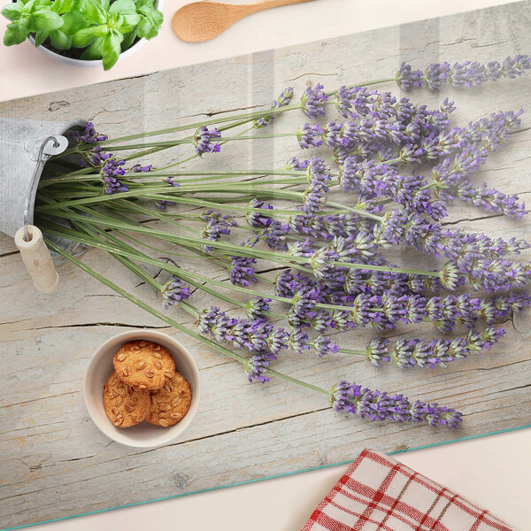 Chopping board glass Lavender in a pot on a wooden background