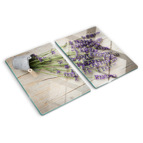 Chopping board glass Lavender in a pot on a wooden background