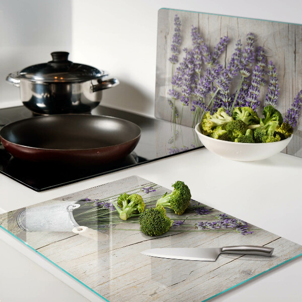 Chopping board glass Lavender in a pot on a wooden background