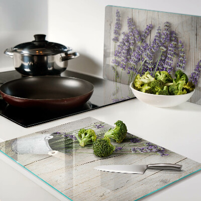 Chopping board glass Lavender in a pot on a wooden background