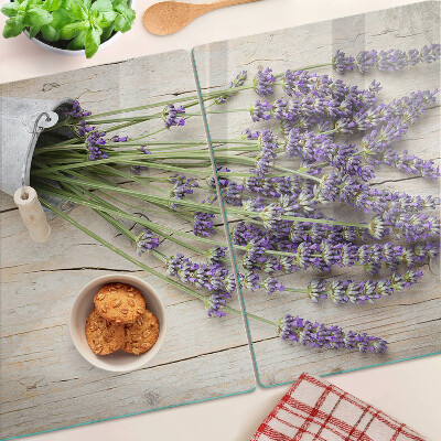 Chopping board glass Lavender in a pot on a wooden background