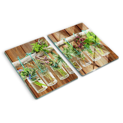 Glass chopping board Herbs in jars on a wooden background